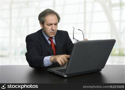 mature businessman working with his laptop at the office
