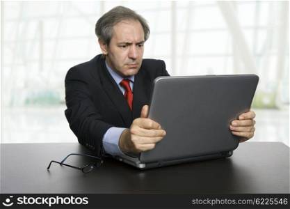 mature businessman working with his laptop, at the office