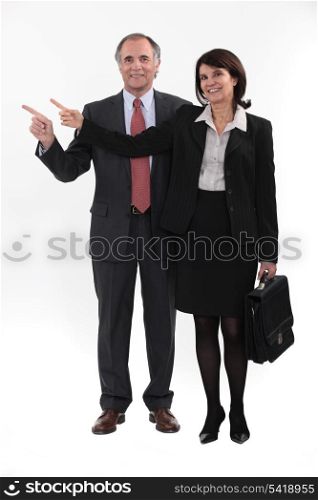 Mature businesspeople standing on white background