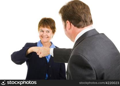 Mature businesswoman giving a fist bump to a male colleague. Isolated on white.