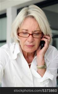 Mature businesswoman making telephone call