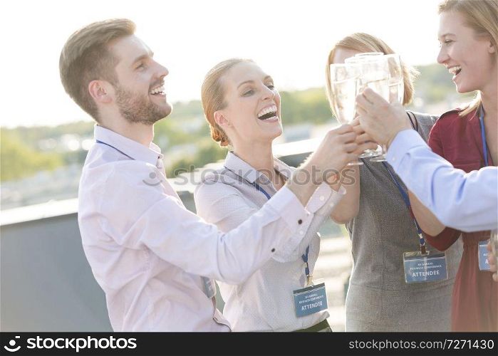 Mature businesswoman shaking hands with businessman during rooftop party