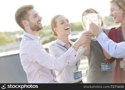 Mature businesswoman shaking hands with businessman during rooftop party