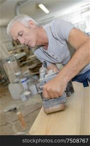 mature carpenter in the workshop