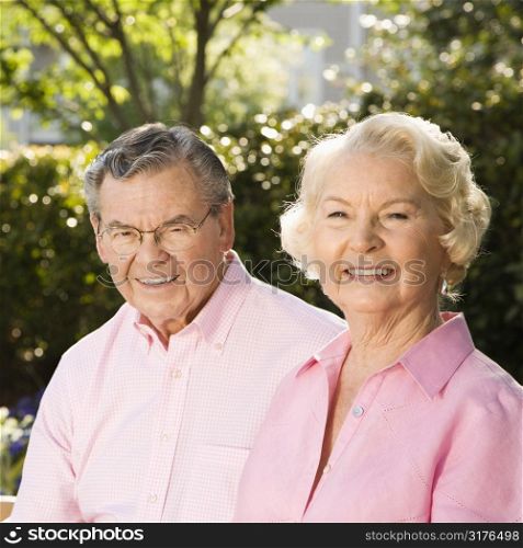 Mature Caucasian couple looking at viewer.