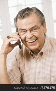 Mature Caucasian man talking on cellphone.