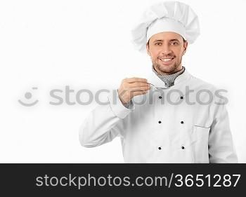 Mature cook with spoon on white background