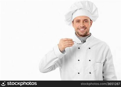 Mature cook with spoon on white background