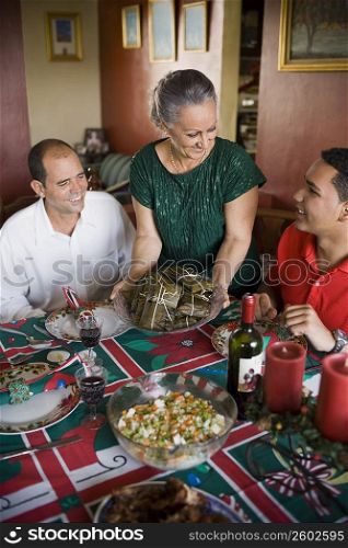 Mature couple and their son at the dining table
