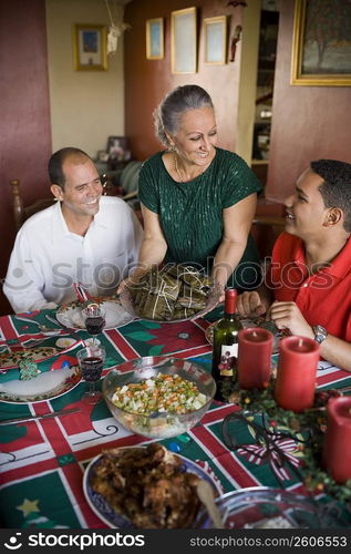 Mature couple and their son at the dining table