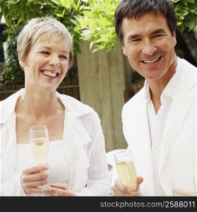Mature couple celebrating with champagne