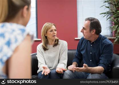 Mature Couple Discussing Problems With Relationship Counselor