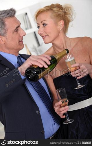 Mature couple drinking champagne