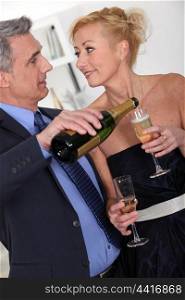 Mature couple drinking champagne