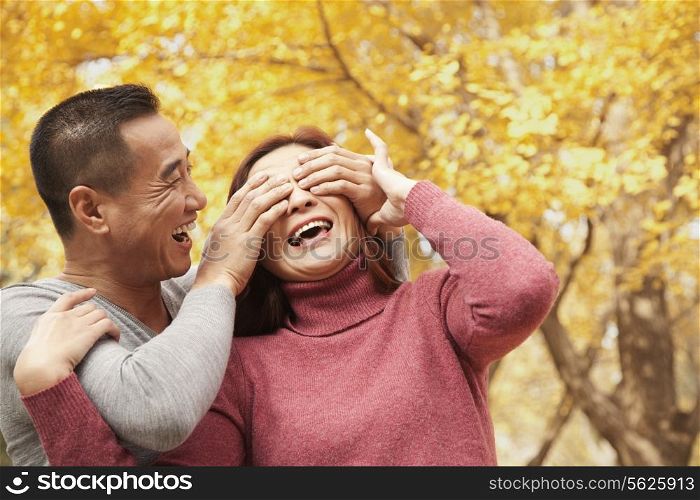 Mature Couple Enjoying a Park in Autumn