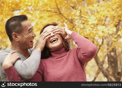 Mature Couple Enjoying a Park in Autumn