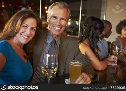 Mature Couple Enjoying Drink In Bar Together