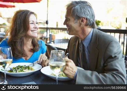 Mature Couple Enjoying Meal At Outdoor Restaurant