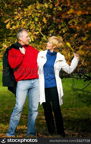 Mature couple having a walk holding each other tight still in love with each other