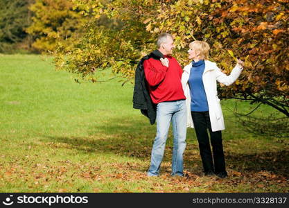 Mature couple having a walk holding each other tight still in love with each other