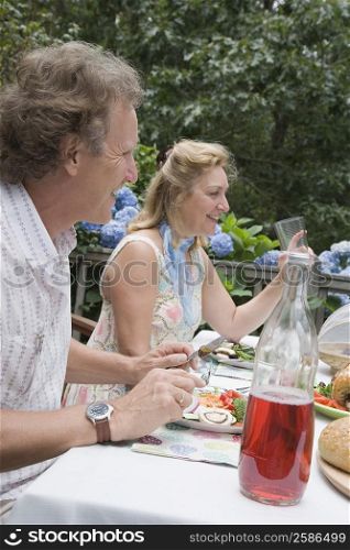 Mature couple having breakfast and smiling