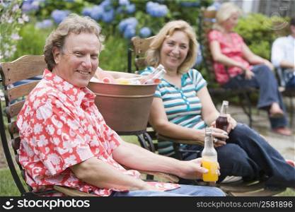 Mature couple holding bottles of cold drink