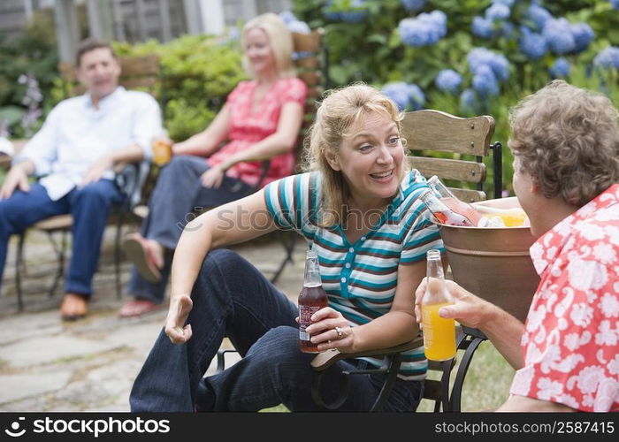 Mature couple holding bottles of cold drink