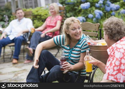 Mature couple holding bottles of cold drink