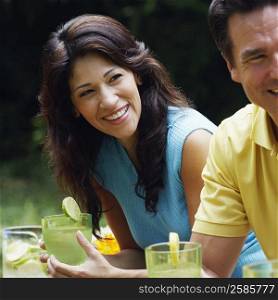 Mature couple holding glasses of lemonade
