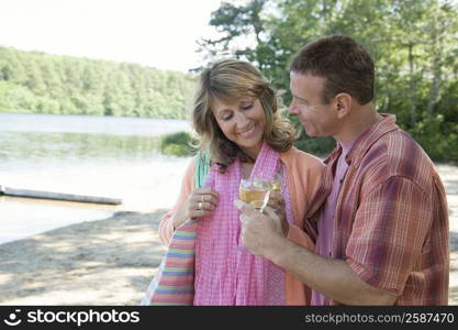 Mature couple holding glasses of wine and smiling