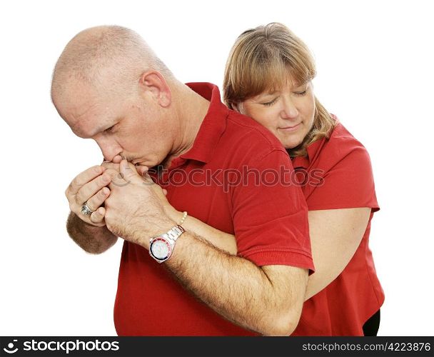 Mature couple in love. She&rsquo;s hugging him and he&rsquo;s kissing her. Isolated on white.