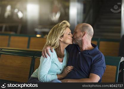 Mature couple kissing in passenger ferry