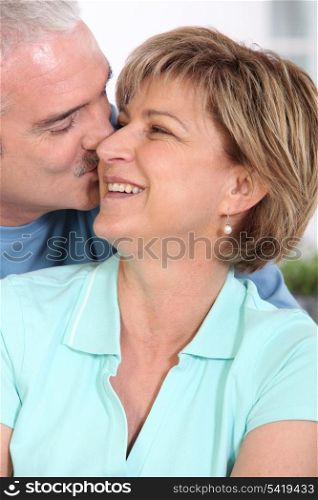 Mature couple kissing tenderly