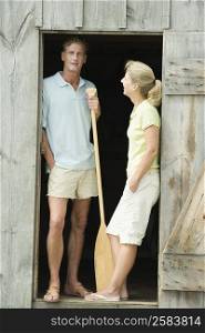 Mature couple leaning against the door of a beach hut
