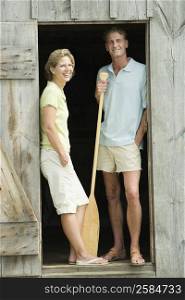 Mature couple leaning against the door of a beach hut