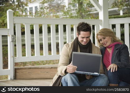 Mature couple looking at a laptop and smiling