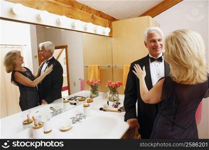 Mature couple looking at each other in the bathroom