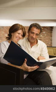 Mature couple looking at photo album