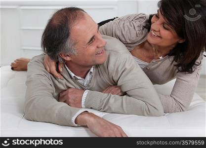 Mature couple lying on a bed