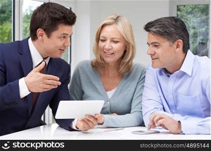Mature Couple Meeting With Financial Advisor At Home