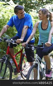 Mature Couple On Cycle Ride In Countryside
