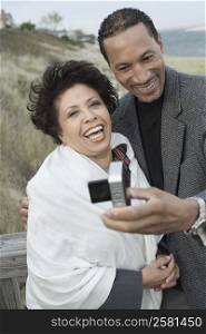 Mature couple photographing of themselves and smiling