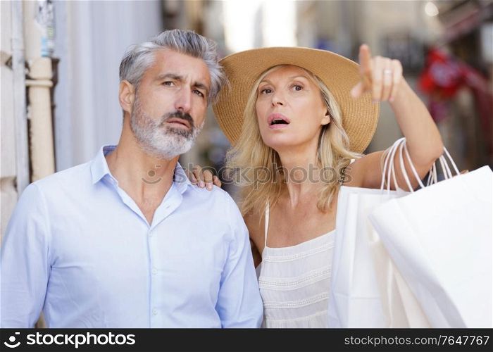 mature couple pointing at something outdoors
