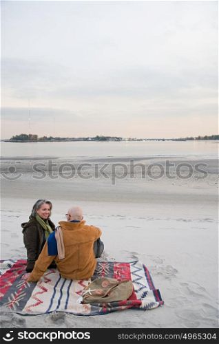 Mature couple resting at the beach