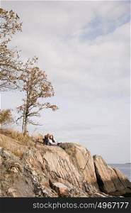 Mature couple resting on rocks