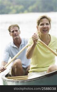 Mature couple rowing a boat