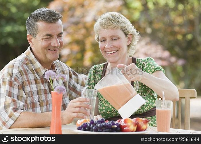 Mature couple sitting at a breakfast table and smiling