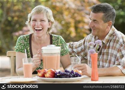 Mature couple sitting at a breakfast table and smiling
