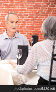 Mature couple sitting at restaurant