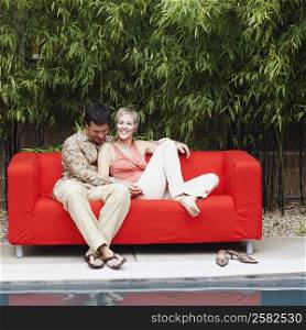 Mature couple sitting on a couch and smiling